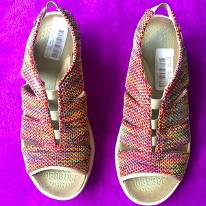 Slip on sandals with stretch strap at heel.